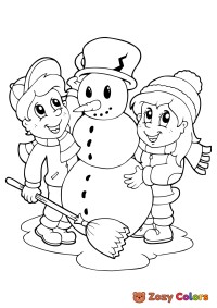 Boy and girl build a snowman